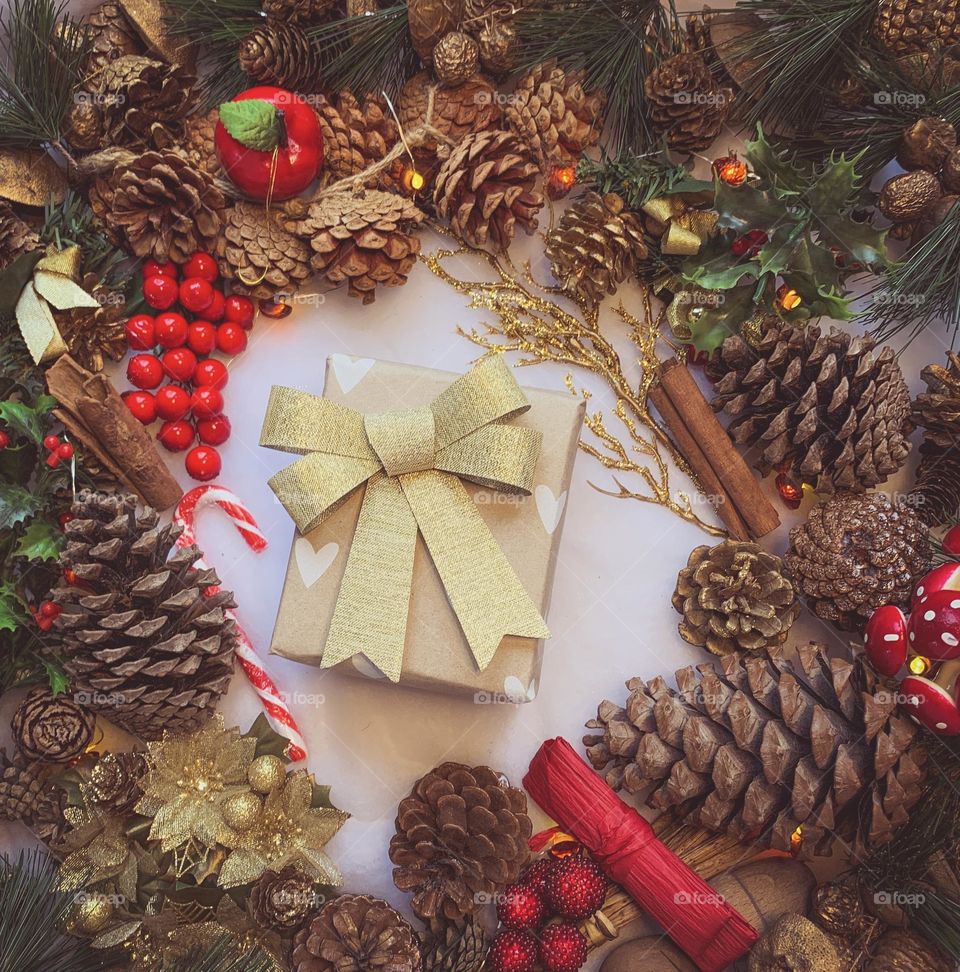 Festive flat lay of decorations centred around a wrapped present