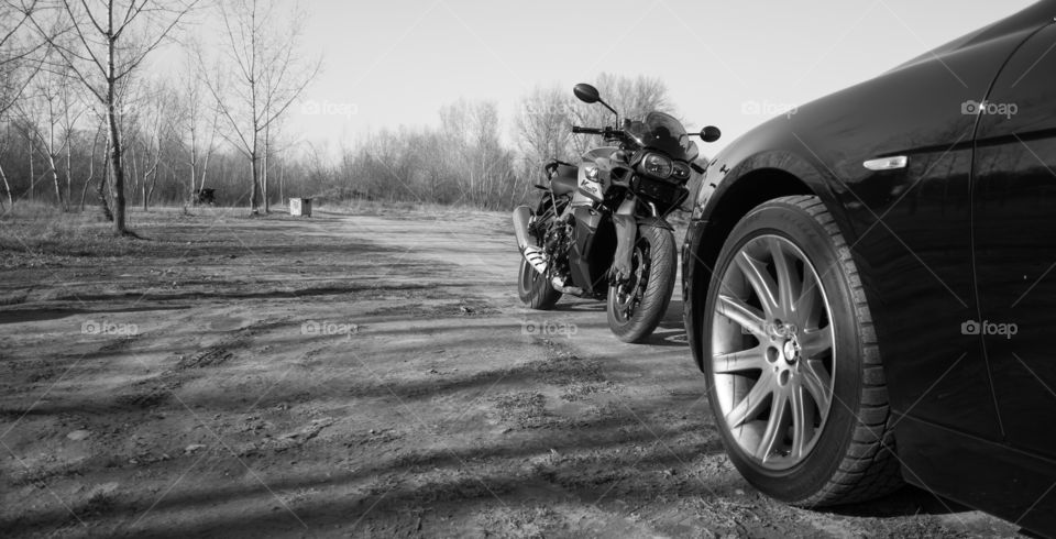 bmw motorcycle and car. bmw k1300r and bmw 750li. black and white photo