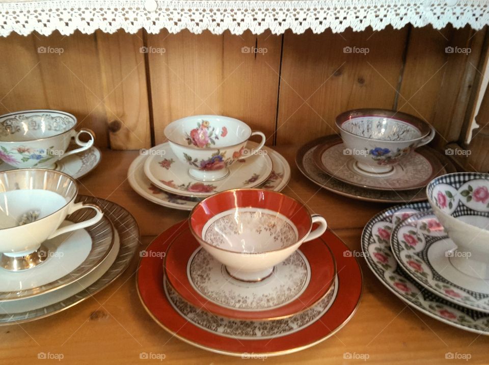 old porcelain presented in an open cupboard