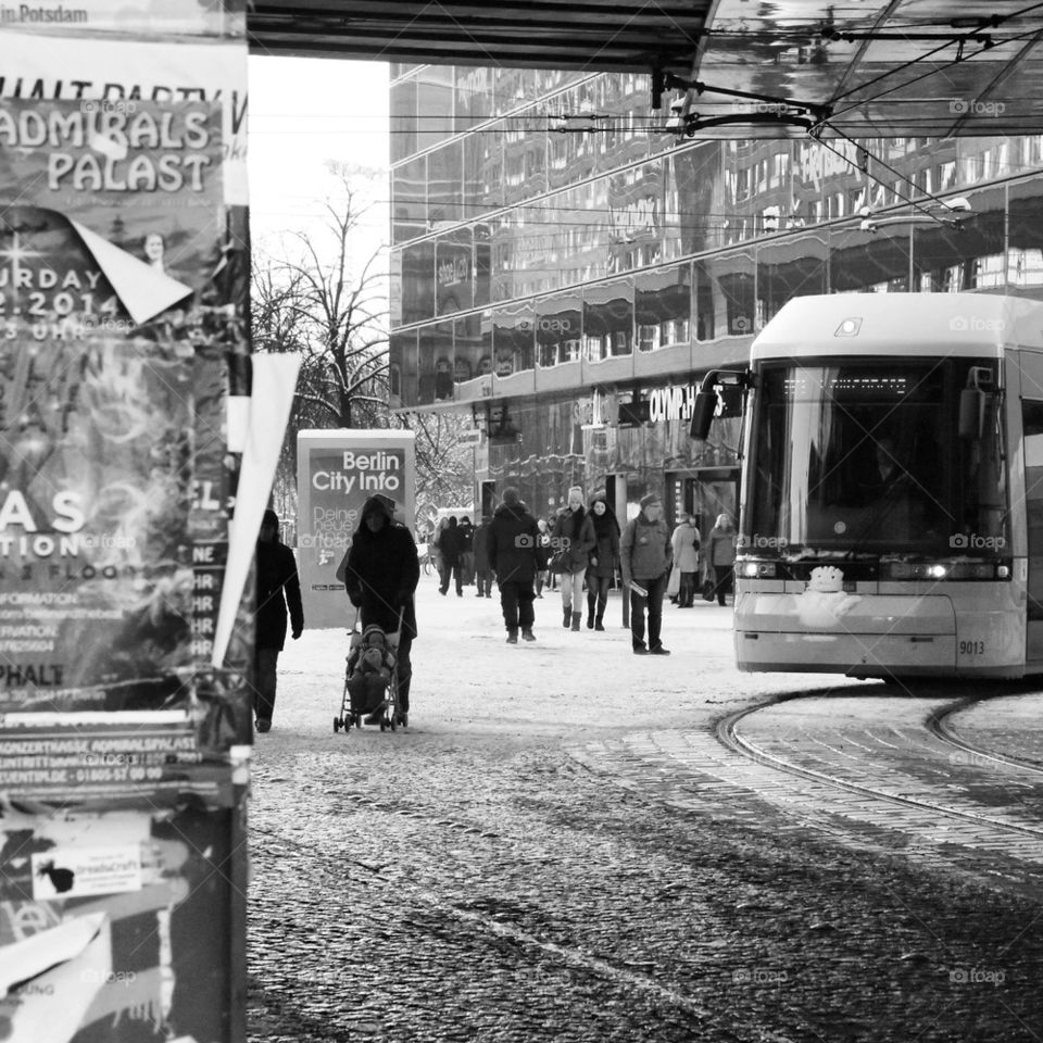 Snow in Berlin . Alexanderplatz in Berlin with train and people