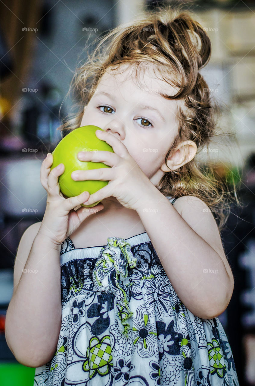 Portrait of girl eating apple