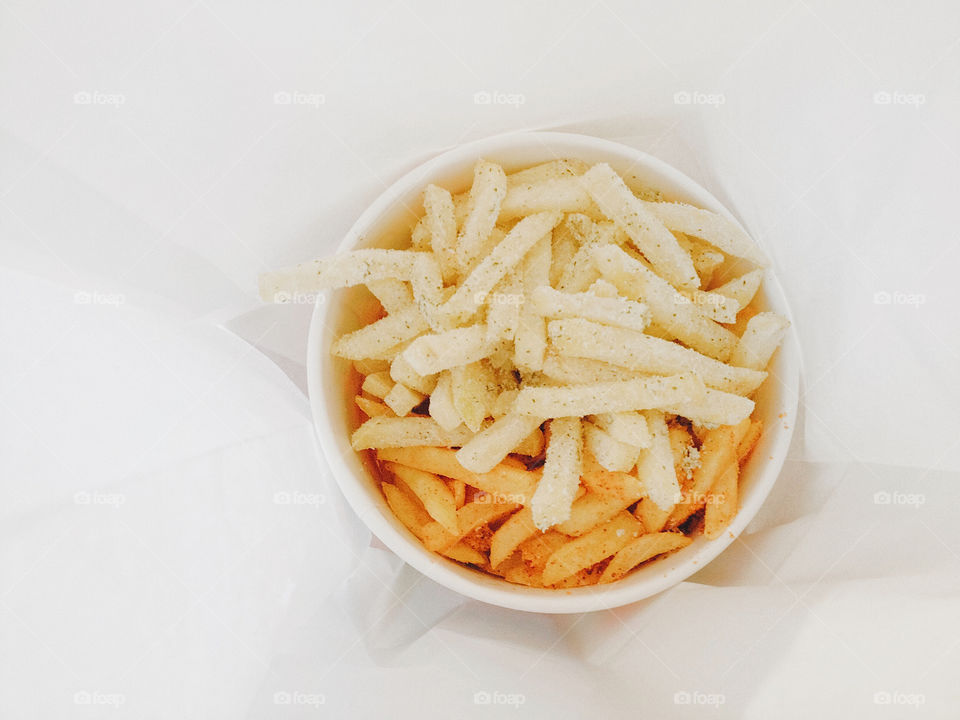 A top view of a Barbeque and Sour Cream-flavored Fries in a container with white background