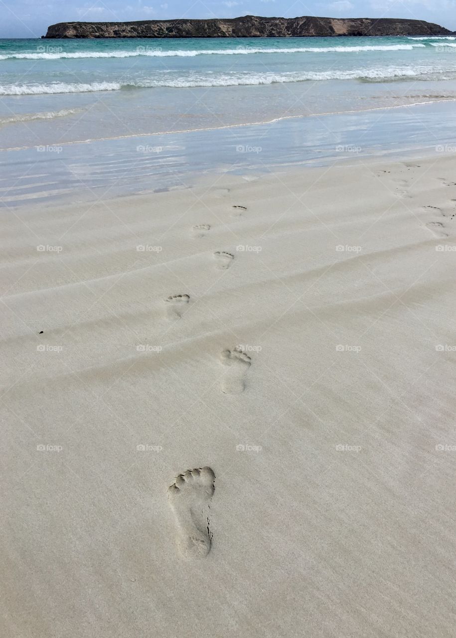 Journey to the sea, footprints in the sand 