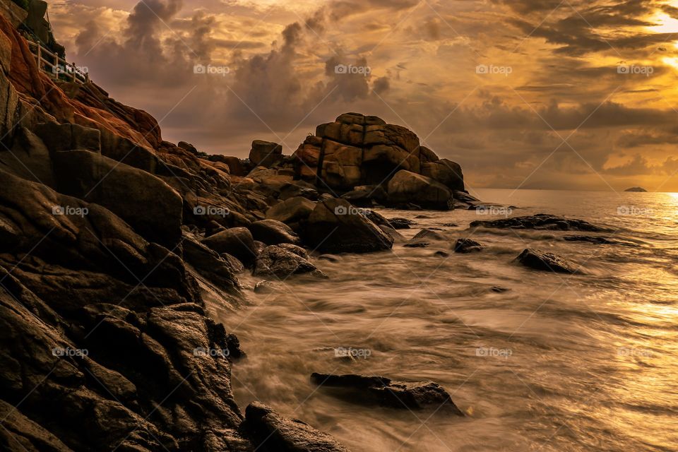 Sunrise at the Rocky Coast of Long chao kok with a dramatic seascapes and moody skies, perfect for the composition.