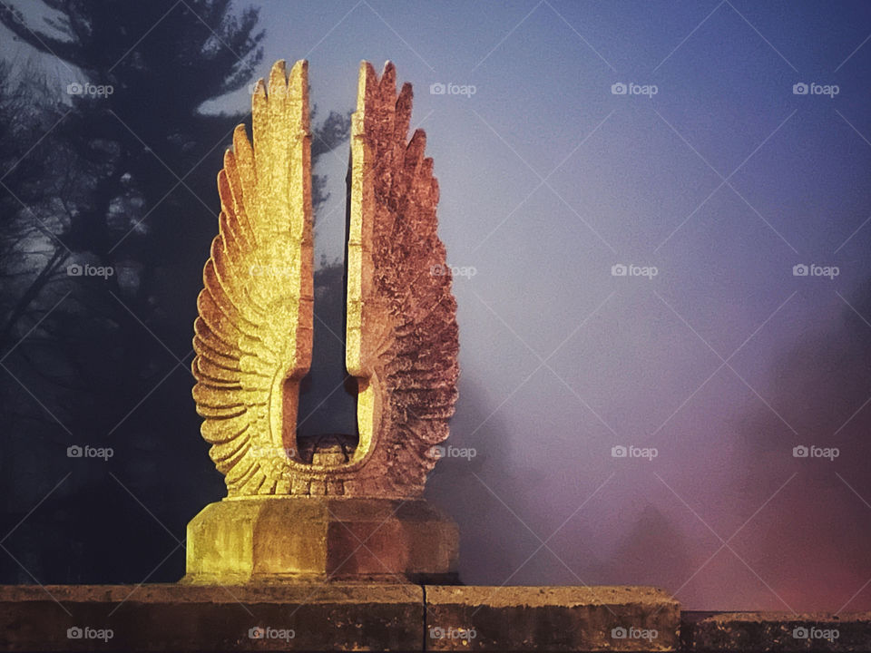 Concrete statue with fog in the background 