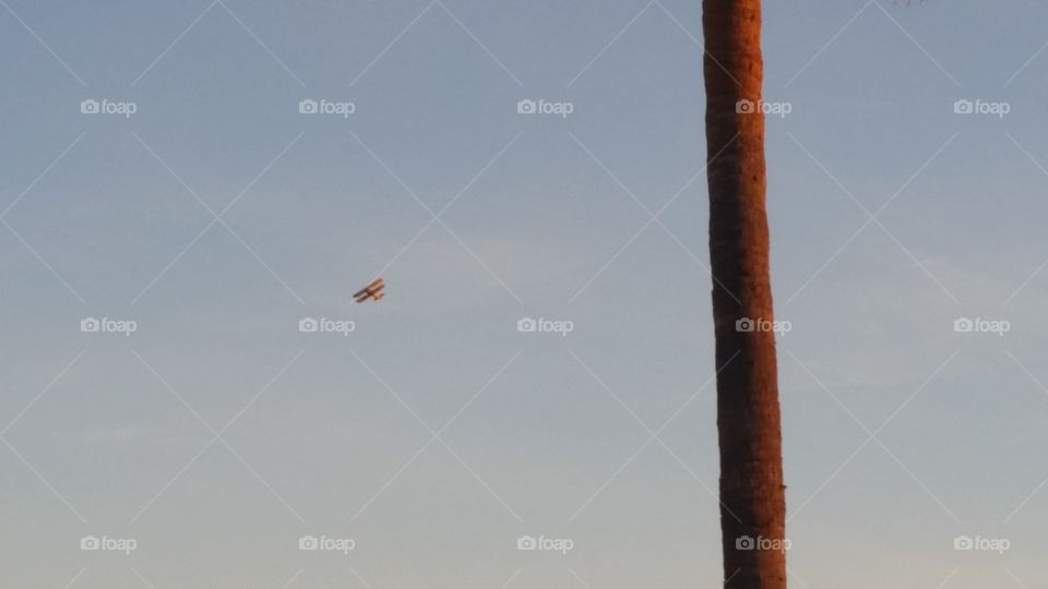 Biplane over beach