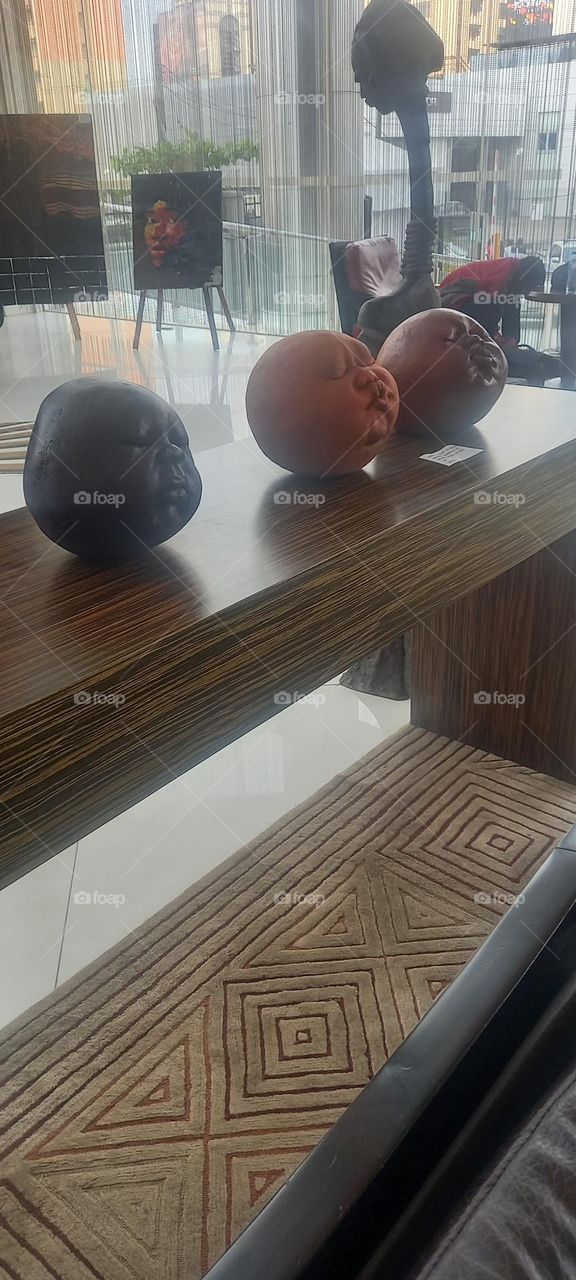 Awesome Art display of round clay faces with various expressions