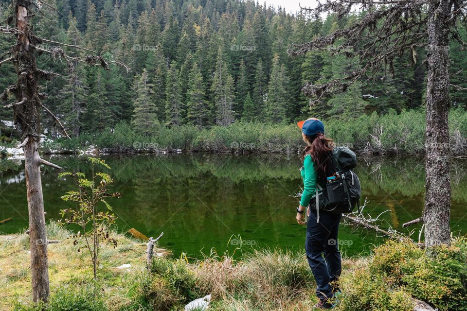 Woman admiring the nature, while on a hike.