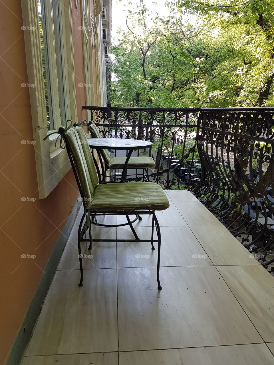 restaurant terrace with empty iron tables and chairs