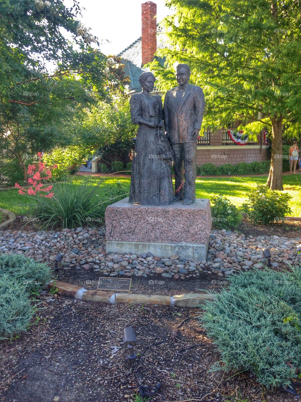 Display of history. Historical home with statue and landscaping