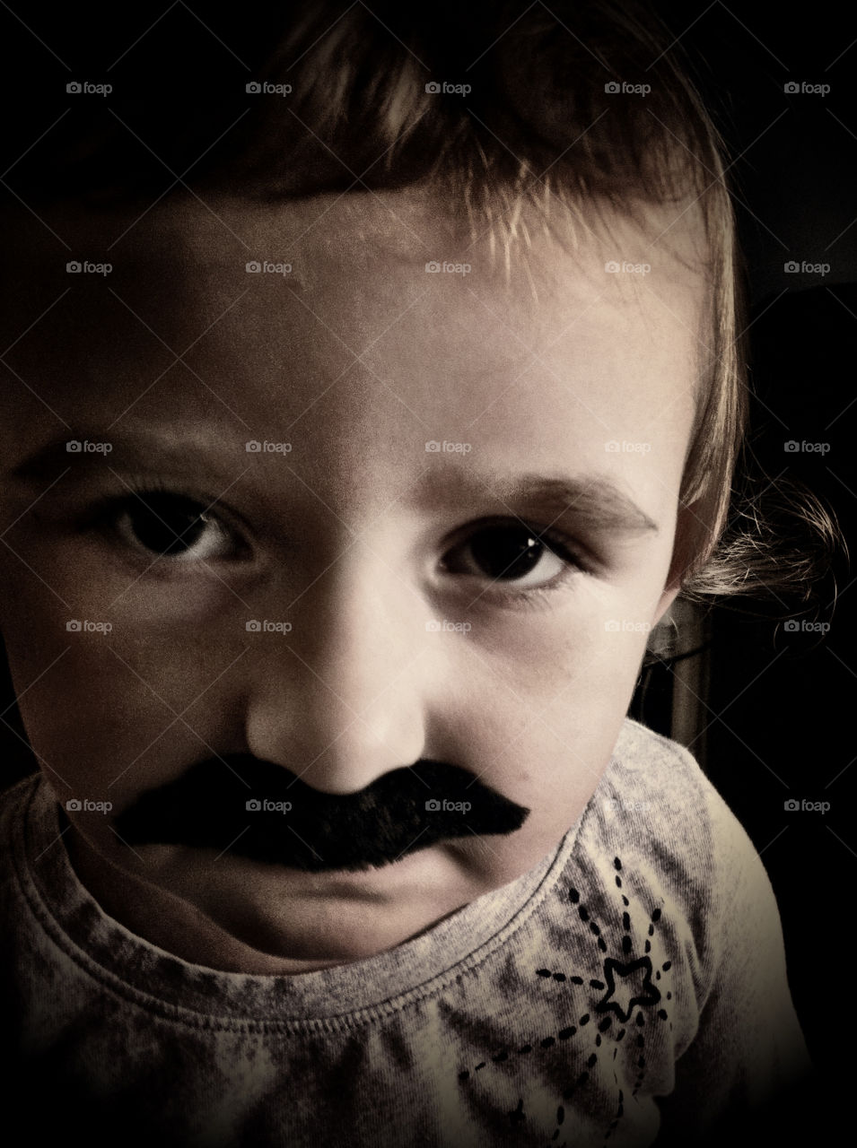 Funny little girl with fake moustache