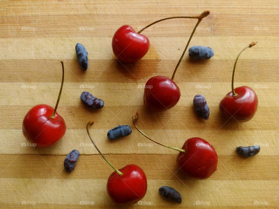 Cherry and honeysuckle . Cherry and honeysuckle on a wooden table