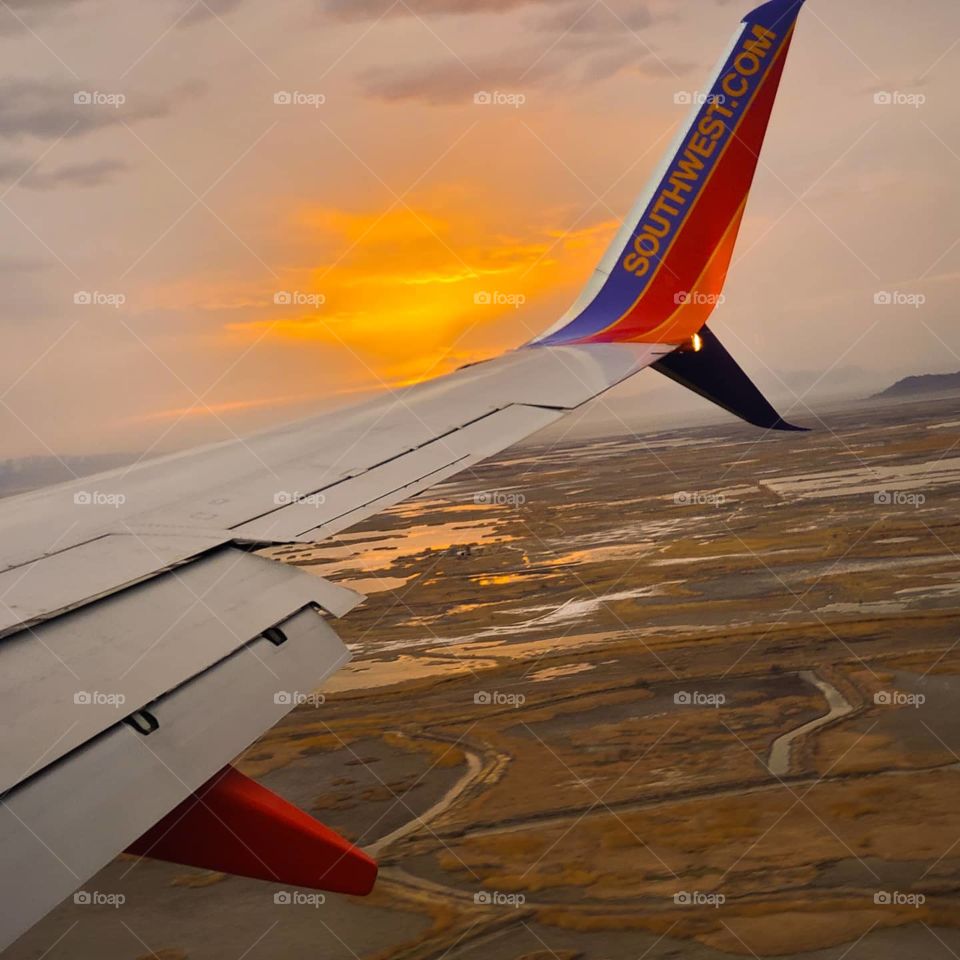 The diffused sunset lights up the sky and the marsh around the Great Salt Lake with a brilliant glow