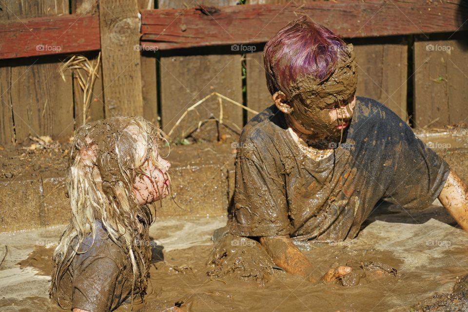 Kids Playing In The Mud