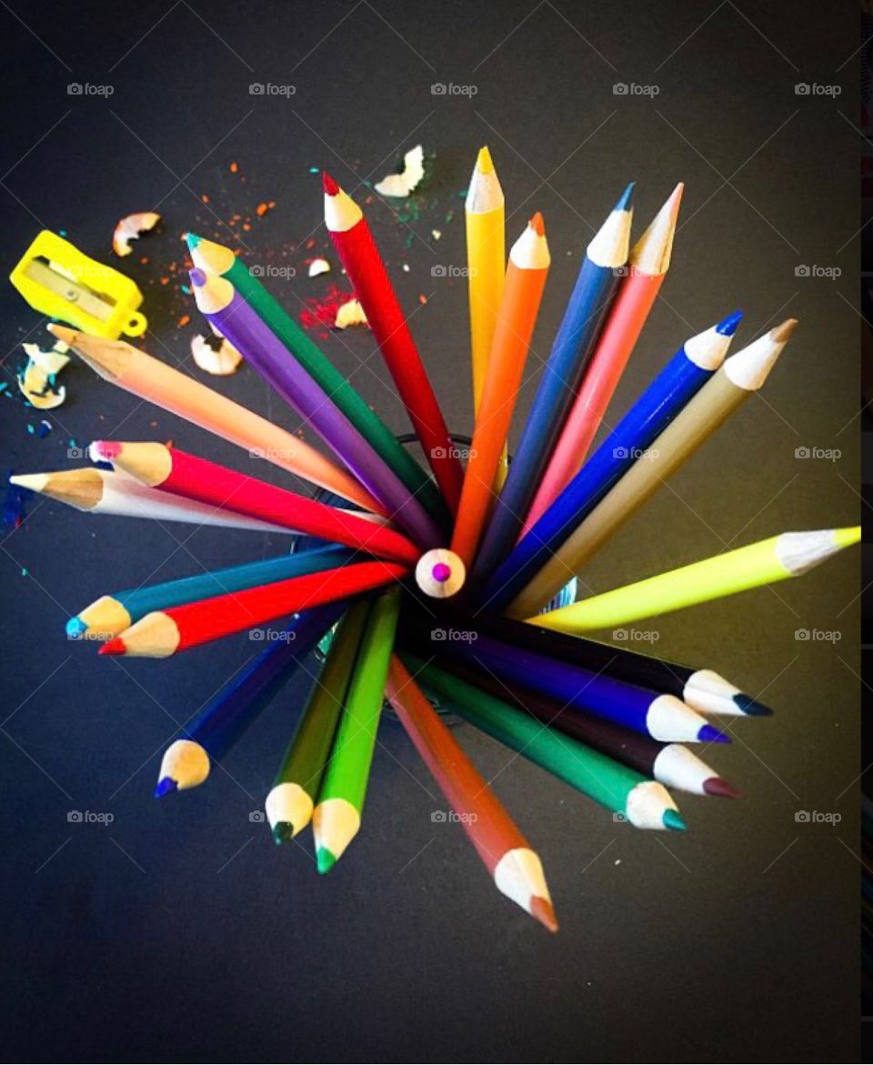 Top view of colored pencils and sharpener