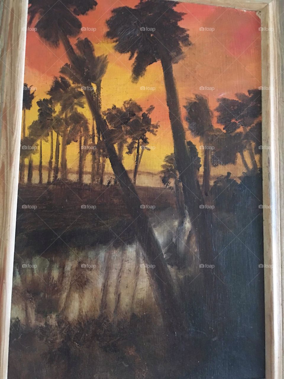 Oil painting of palm trees in South Florida silhouetted at sunset and reflected in still water off ocean 