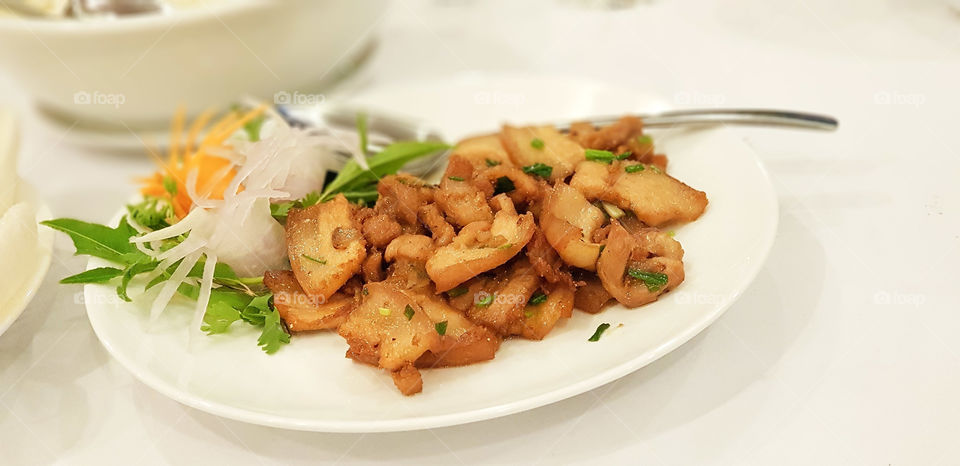 Fried pork belly with spring onion
