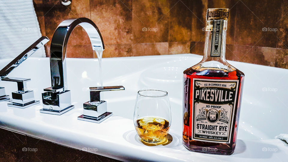 whiskey bottle by the jacuzzi