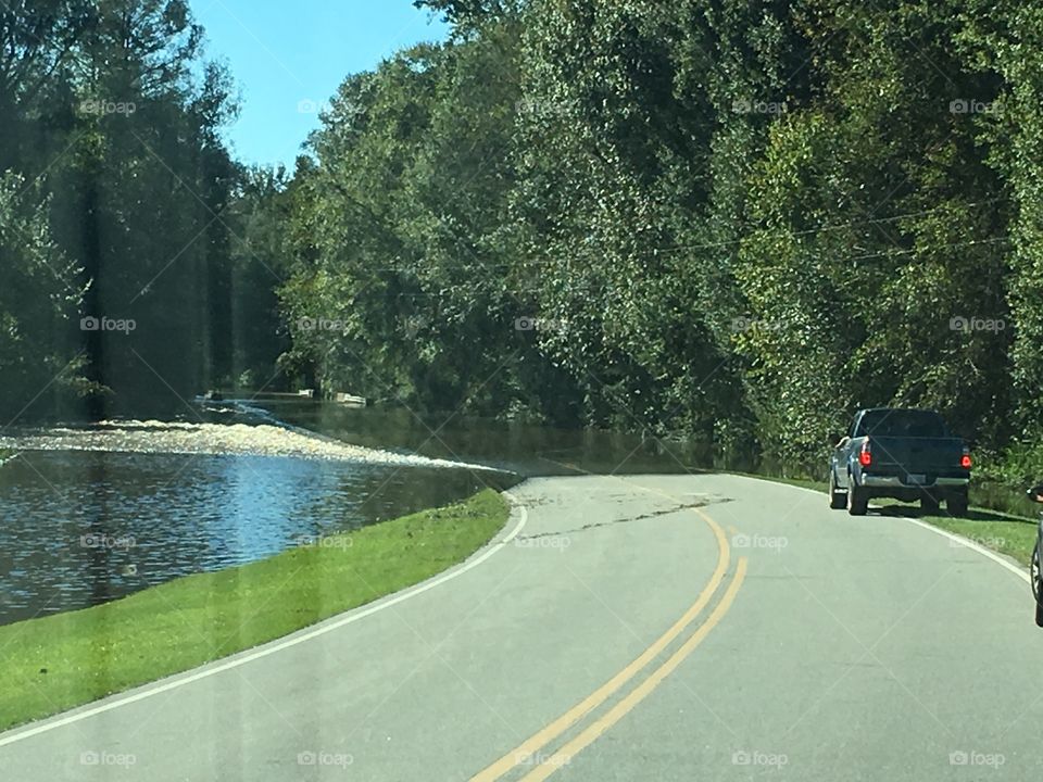 River flooding over road