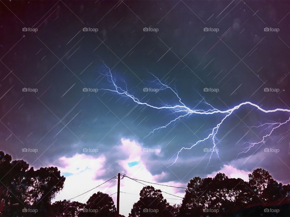 Lightning storm , dark clouds and rain.