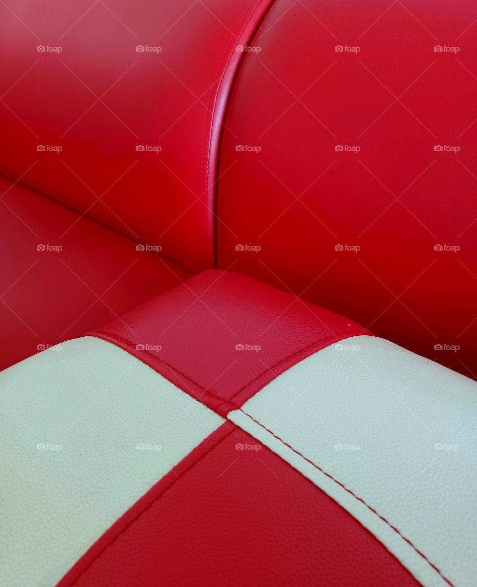 Red with white cushion on the red couch.