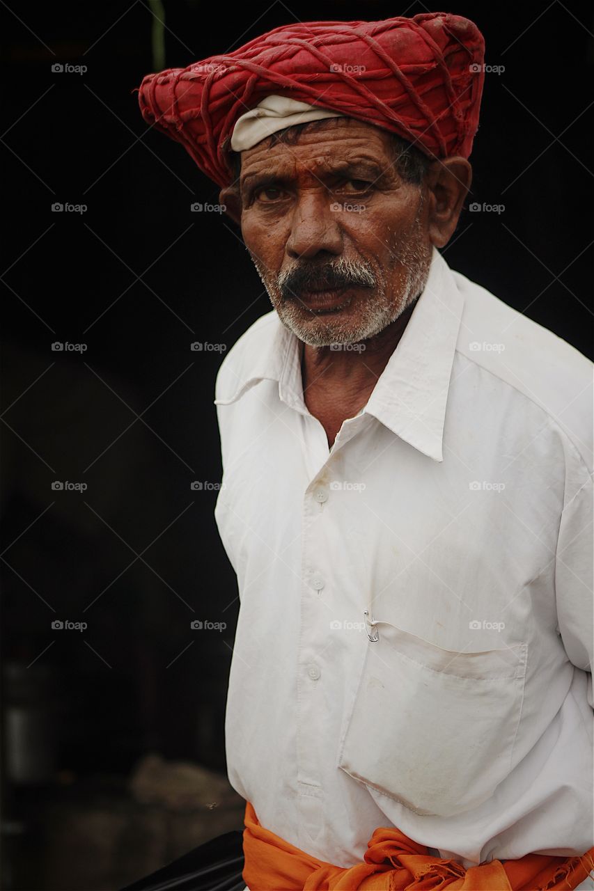 "At the end of the day, the face we have the courage to still be standing is enough of a reason to be happy and celebrate". 

This portrait is of Bhau Vitthal Rao. He is resident of Singhad Fort, Pune India and he is one person who knows the complete story of Sivaji bravery and Maratha war in times of Mughal empire in india. Bhau is a determined and strong willed person with a shine in eyes and always singing songs of bravery and winning. Positive thoughts and strong determination is part of his nature. ( Model Release - available and provided on request). #FOAPNATION @doondevil 