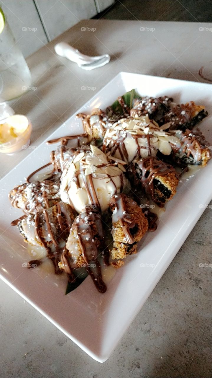 Oreos Cookies N Creme Tempura with Vanilla Ice Cream Topped With Hazelnut Drizzle and Almond Flakes