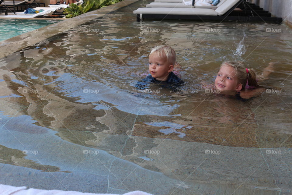 Children having summer fun on a pool 