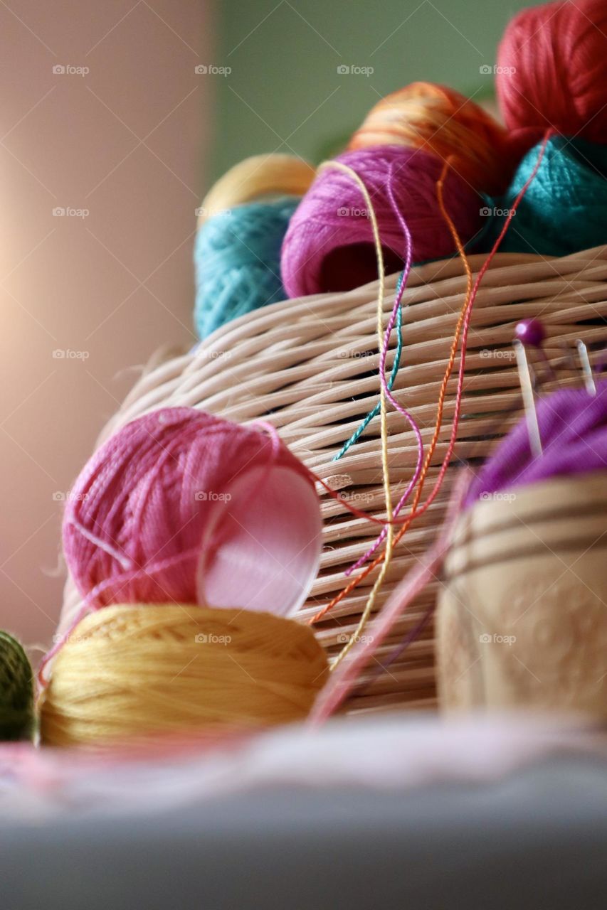 Colourful embroidery threads in a bask 