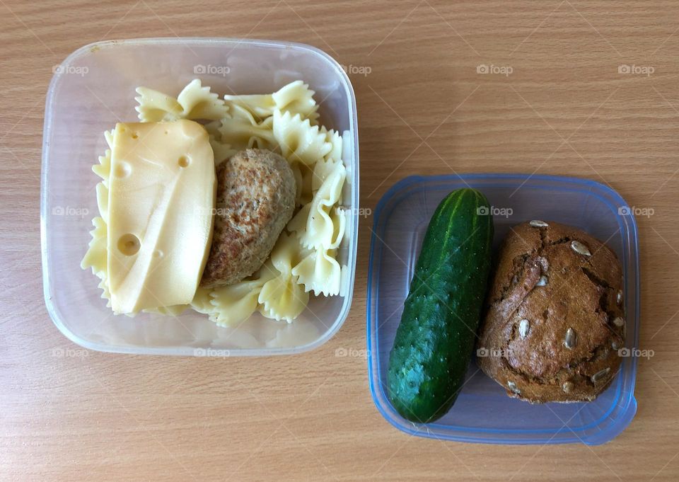 Lunch with pasta, cutlet, cheese, cucumber and bread 