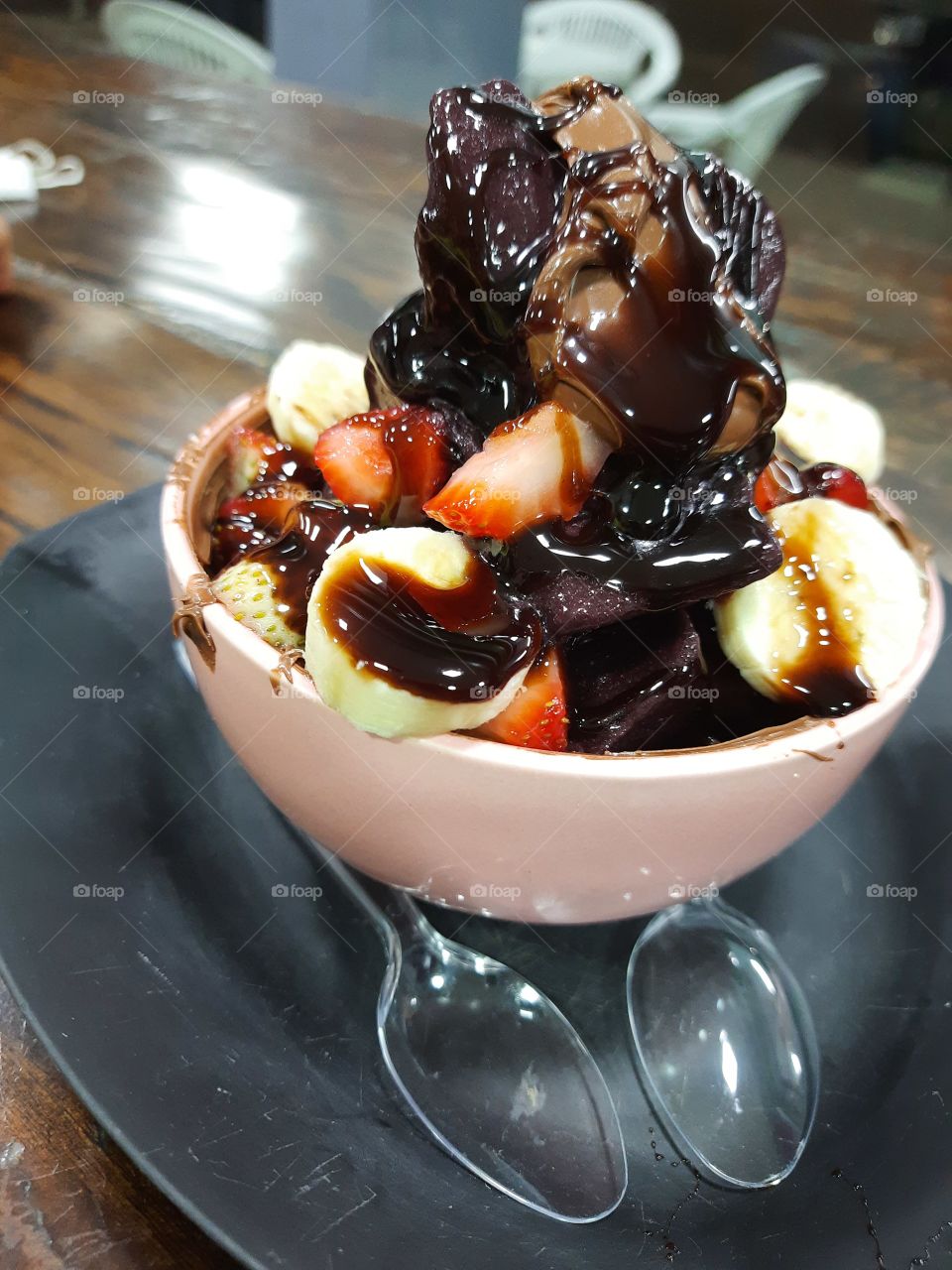 Açaí bowl with strawberry banana nutela and chocolate icing