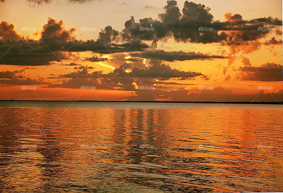 Cascading clouds over the sunset