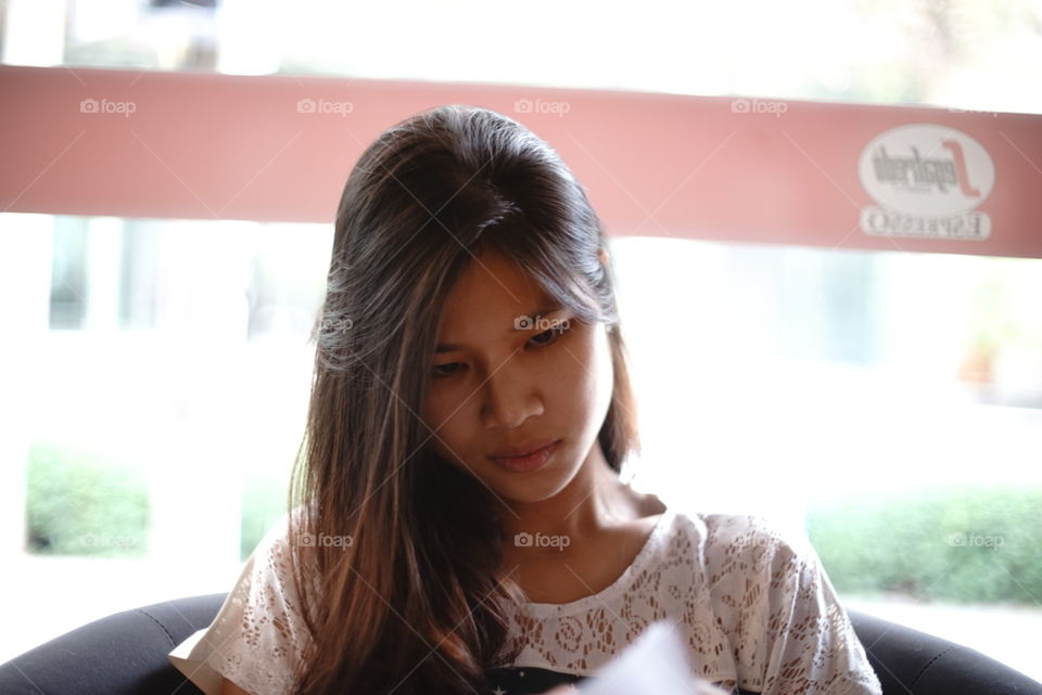 Cute Asian girl in coffee shop