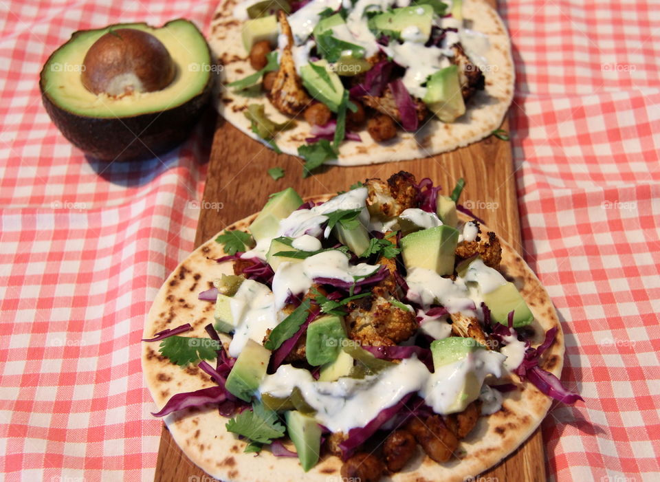 Homemade roasted cauliflower and chickpea taco with lime and cilantro yoghurt dressing