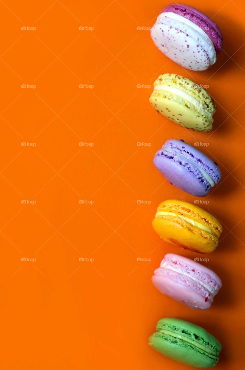 Macaroons on orange background