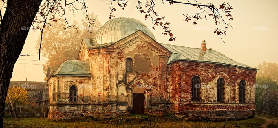 Old Christianity church at autumn misty morning 