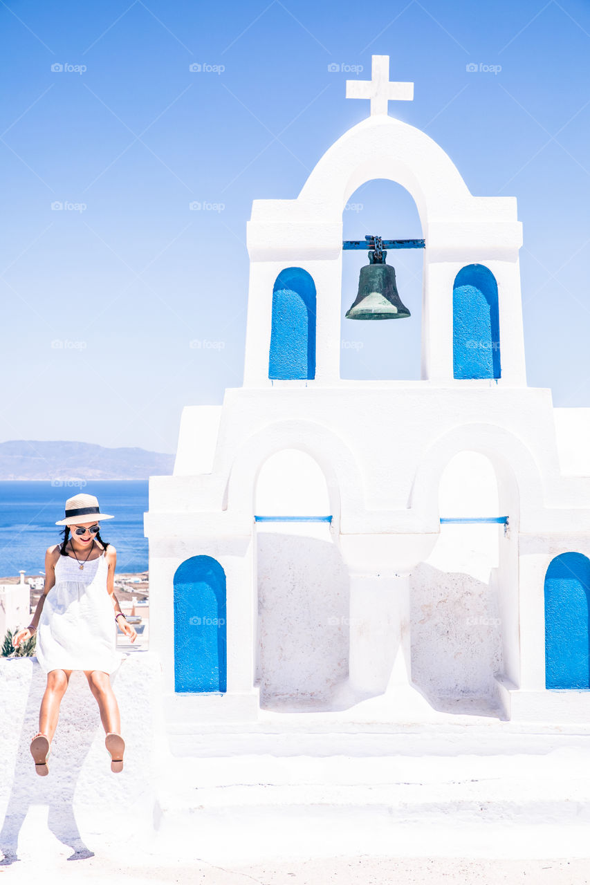 Young Tourist Woman On Vacation In Famous Greek Island Santorini
