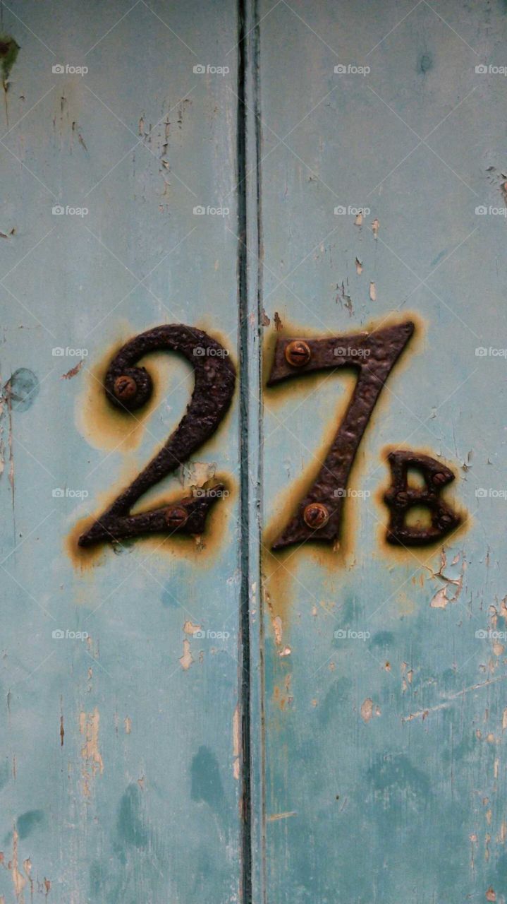 27b rusty numbers on a blue door