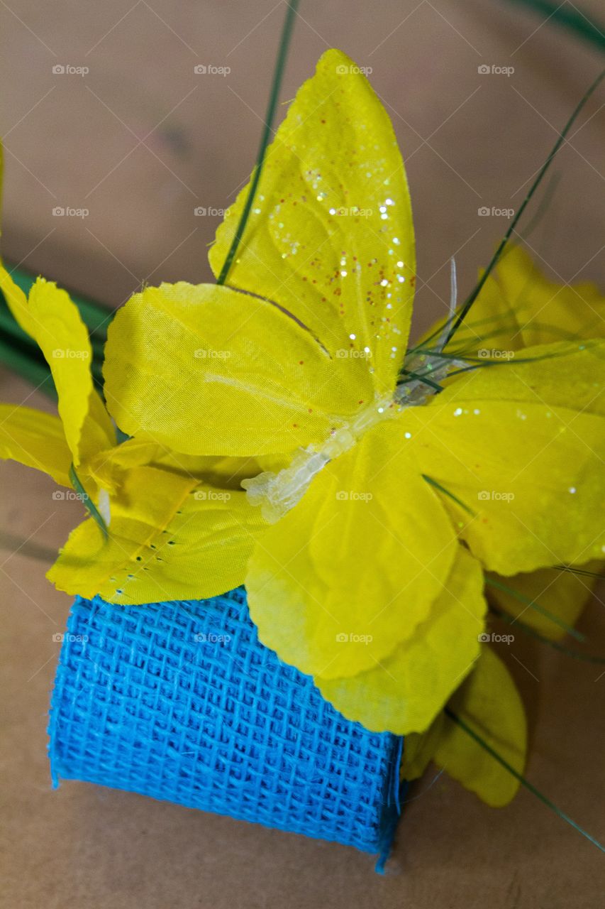 Yellow flower and blue ribbon