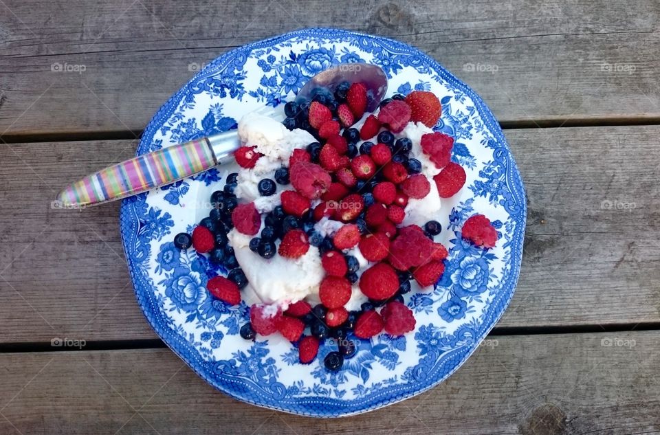 Ice cream and berries  . Ice cream and fresh berries on a plate