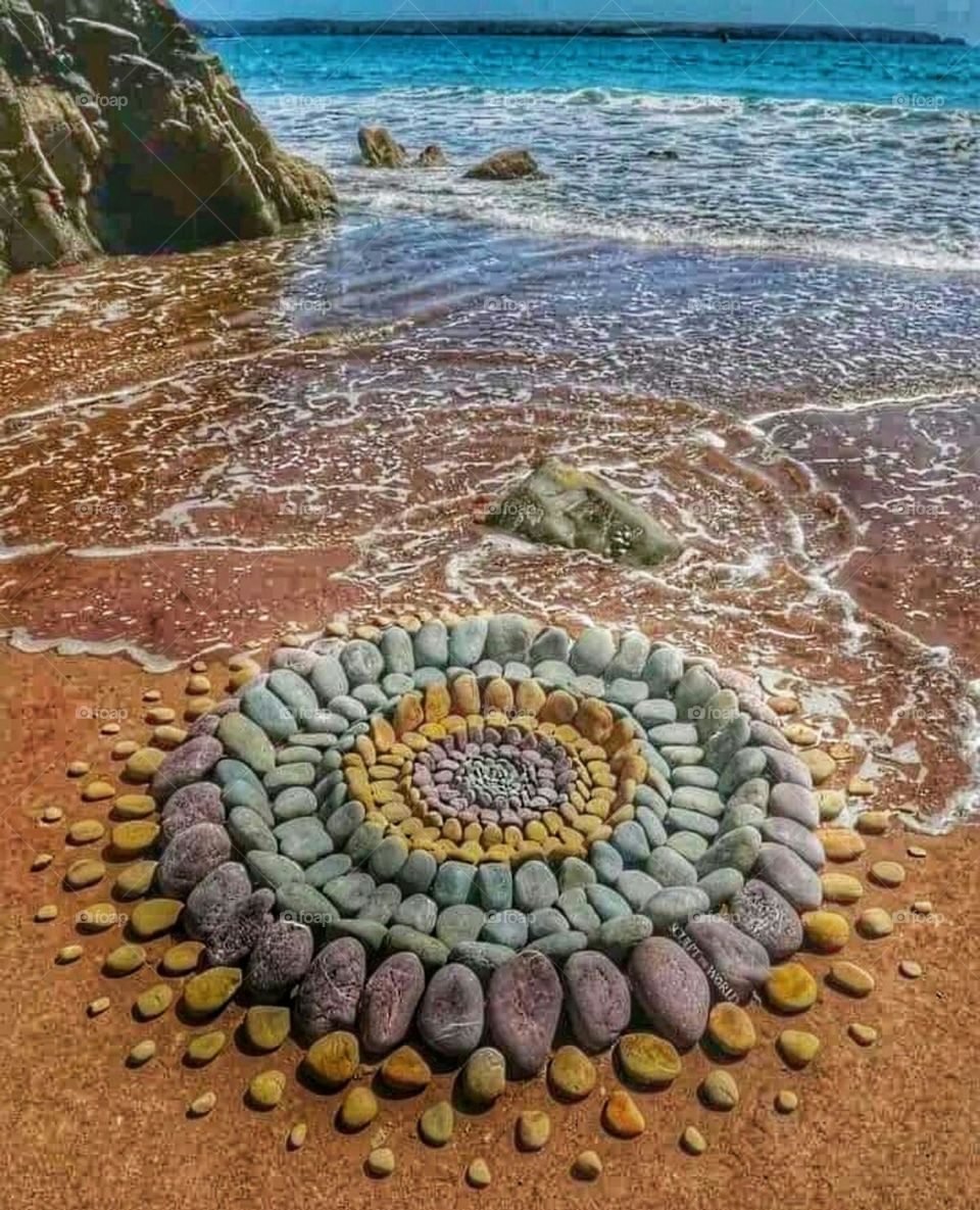 Painting with stones on the beach