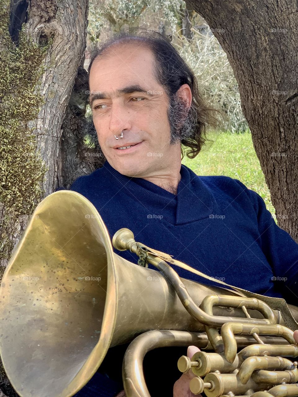 Father of 2 Ricardo relaxes with him tuba.