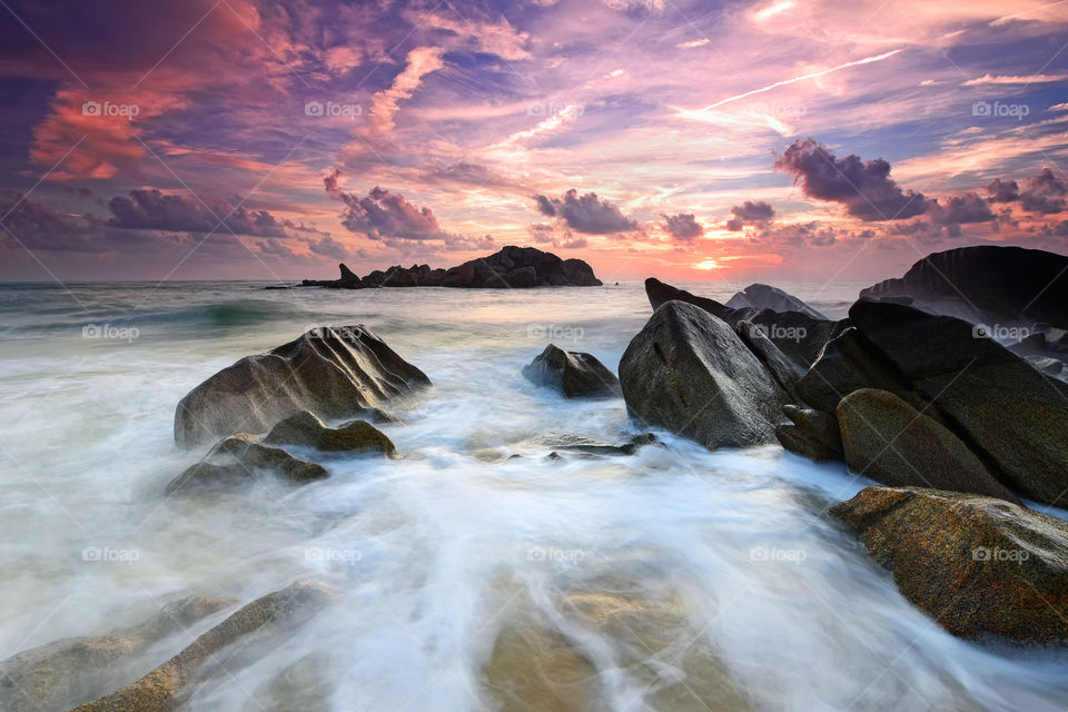 Dramatic sunset over the rocky beach