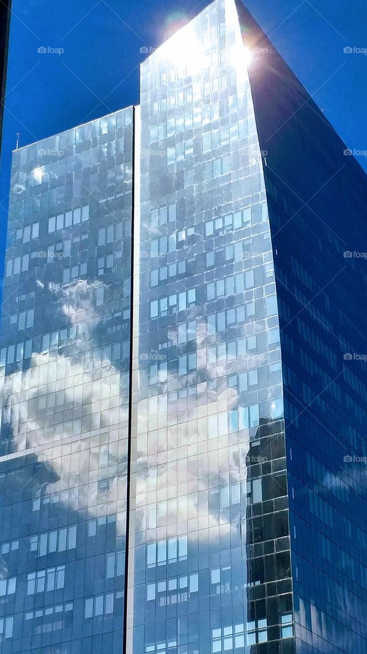 Reflection of the clouds in the mirrored building