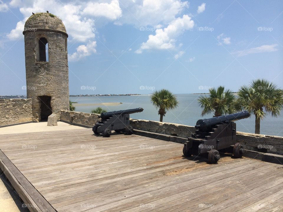 Ancient cannons overlook the shores of Matanzas Bay in Castillo de San Marcos National Monument, St. Augustine, Florida. 