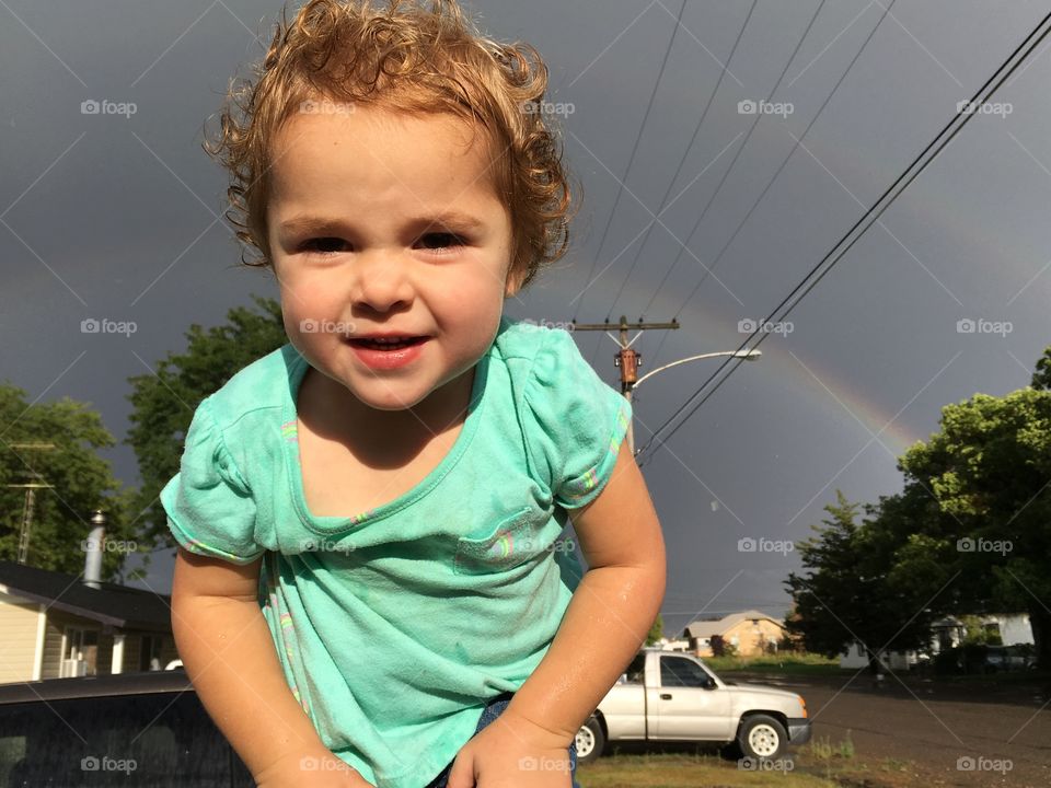 Baby girl under the rainbow.