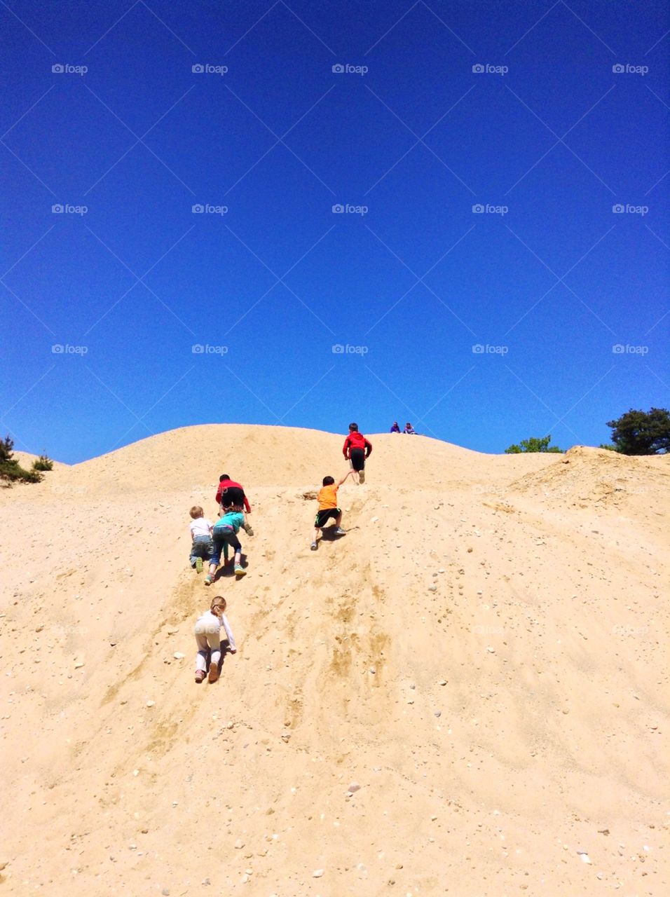 Kids climbing sand dunes . Kids climbing sand dunes 