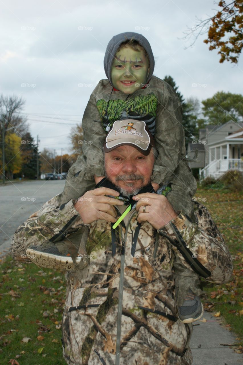 Parent carrying child on shoulder