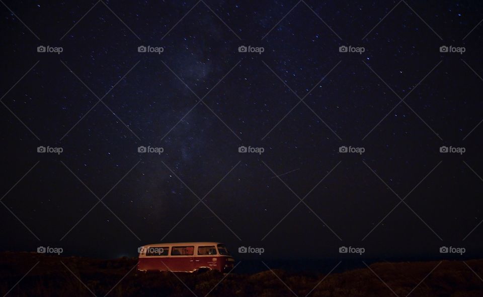 Stargazing under the milky way in a camper van
