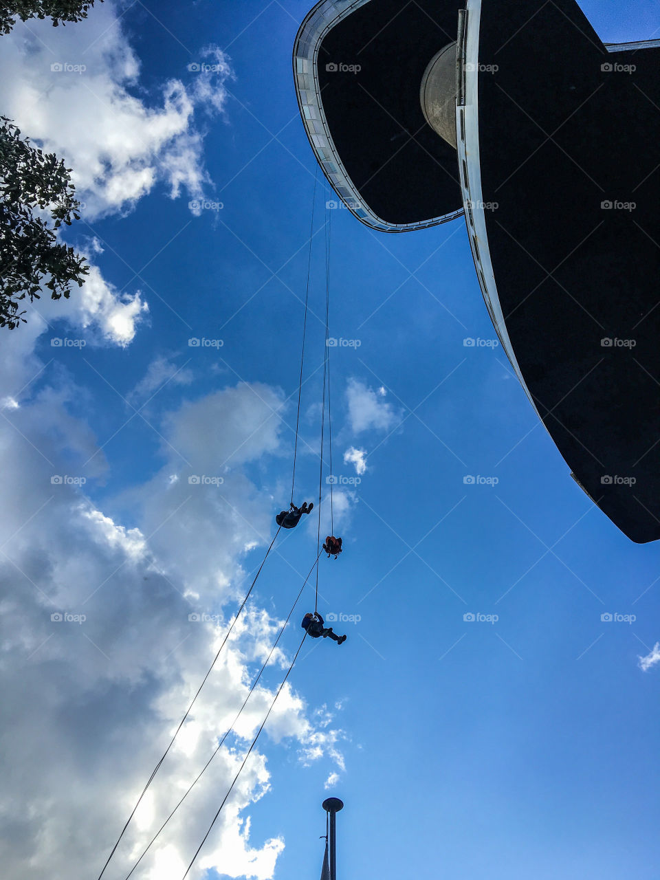 Silhouette of People practicing abseiling at Euromast, Rotterdam, The Netherlands 